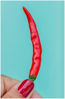 holding cayenne pepper in between two fingers